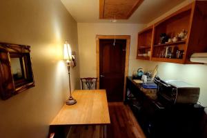 a small kitchen with a table and a microwave at Cascina Rococo at White Lotus Eco Spa Retreat in Stanardsville