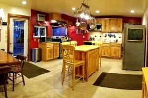 a kitchen with wooden cabinets and a table and a refrigerator at Crows Nest in Stanardsville