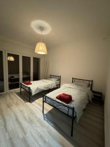 a bedroom with two beds and a chandelier at Lavanda House in Vicenza