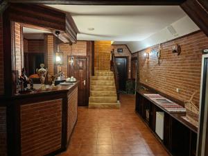a room with a staircase and a brick wall at Millenium Castle Sibiu - Parking on Site - BIKERS' Haven in the Heart of Romania's Legendary Roads - Rest in Comfort # in Sibiu