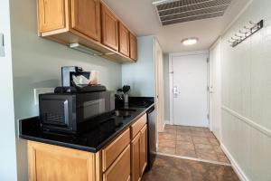 a kitchen with a counter top with a microwave at Oceanview Oasis 7th Floor King Room in Pawleys Island