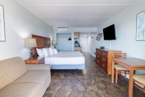a hotel room with a bed and a couch at Oceanview Oasis 7th Floor King Room in Pawleys Island