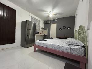 En eller flere senge i et værelse på Cancun Estudio 9-C