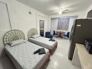 En eller flere senge i et værelse på Cancun Estudio 9-C