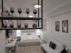 a bedroom with a bed and a desk and a sink at Cozy Di.Va city centre in Thessaloniki