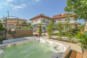 a hot tub in the backyard of a house at Happy Apartments in Balatonlelle