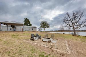 a group of chairs and a table in a field at Van Vacation Rental with Private Lake Access and Dock in Van