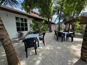 a group of tables and chairs in front of a building at Ithaa Hiya Dhihfushi in Dhiffushi