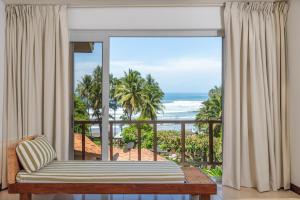 a bedroom with a view of the ocean at Las Flores Resort in Chirilagua