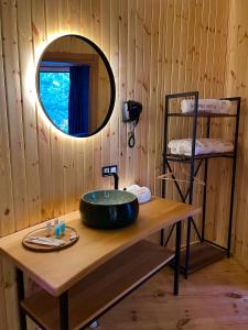 ein Badezimmer mit einem Waschbecken und einem Spiegel auf dem Tisch in der Unterkunft Glamping Martini Kvariati in Batumi