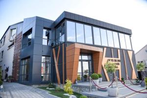 a large building with glass windows on a street at Hotel Euforia Lounge in Šabac