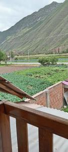 a balcony with a view of a field of crops at Casa de George in Urubamba