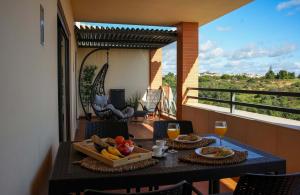 a table with a tray of fruit on a balcony at Apartamento Panoramico - By Dalma Portuguesa in Branqueira