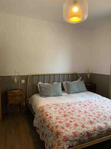 a bedroom with a bed with a floral comforter at "Villa I Rottani" Magnifique villa avec piscine privée in Aléria