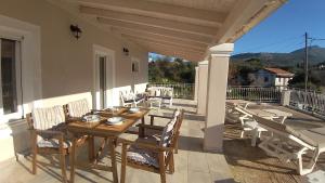 a wooden table and chairs on a patio at Casa Sulla Montagna in Loutses