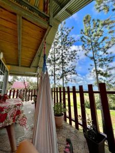 a hammock on a porch of a house at CABAÑAS EL CHEPO in Chepo