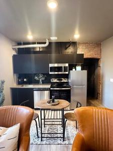 a kitchen with a table and a refrigerator at Stylish Cozy Studio in Detroit in Detroit