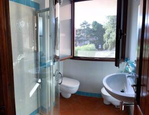 a bathroom with a shower and a toilet and a sink at Splendida vista mare zona centrale Porto Rotondo posto auto privato in Porto Rotondo +68 photos