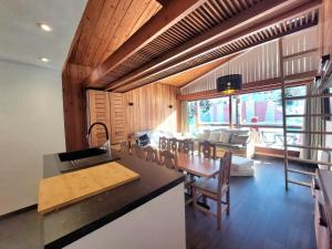 a kitchen and living room with a table and a couch at Appartement spacieux et rénové - Ski aux pieds - Balcon - Wifi - 8/9 pers - FR-1-346-553 in Arc 1800