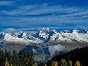 a snow covered mountain range with trees in the foreground at Studio ski aux pieds avec balcon et fibre, 5 pers - FR-1-346-555 in Arc 1800