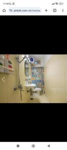 a bathroom with a sink and a mirror at Nemohousehomestay in Hanoi