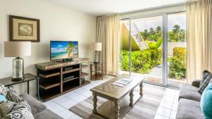 a living room with a couch and a table at Beach Living at Island Pine Villas BLP in George Town