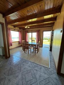 a dining room with a table and chairs at Casa 48 in El Calafate