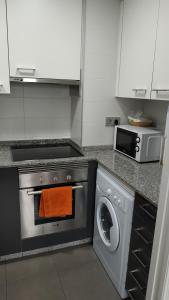 cocina con lavadora y microondas en Apartamento ANA - 1 Habitación en A Coruña