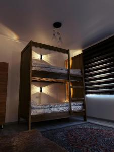 a bedroom with a bunk bed with a bunk bedoublengthngthngth at Irbis Hostel in Karakol