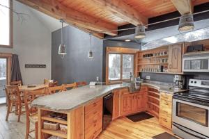 a large kitchen with wooden cabinets and a dining room at Divided Sky in Lead