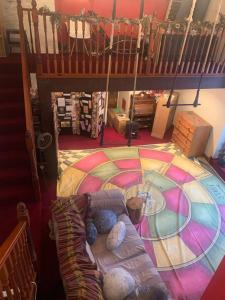 a room with a large colorful floor with a couch at Spacious, Sunny Double Bedroom in Home Stay Quirky Cottage, Near Holmfirth in Holmfirth