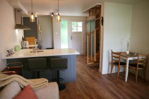 a kitchen with a counter and a table in a room at Blainroe Cottage in Blainroe