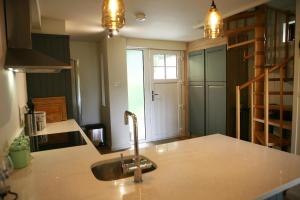 a kitchen with a sink and a counter top at Blainroe Cottage 