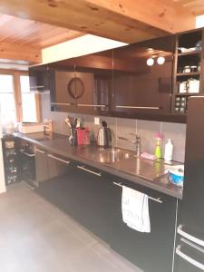 a kitchen with a sink and a counter top at Charme et authenticité in Evolène