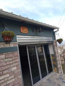 a coffee shop with a sign above the door at Hostel Mateo in Gjirokastër