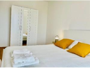 a bedroom with a white bed with towels on it at One bedroom flat with terrace and parking in Luxembourg