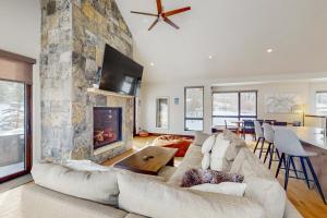 a living room with a couch and a fireplace at A Slice of Silverthorne in Silverthorne