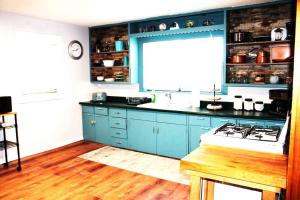 a kitchen with blue cabinets and a stove in it at The Hunter Anderson in Mulberry