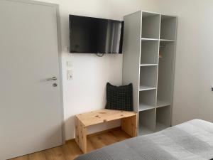 a bedroom with a bed and a desk and a tv at Apart Mark, Stanz bei Landeck - Moderne Wohnung in sonniger Lage in Stanz bei Landeck