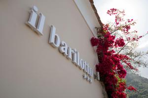 a sign on the side of a building with flowers at Il Barilotto in Positano