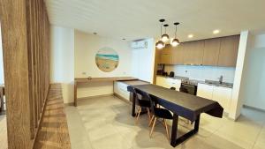 a kitchen with a table and chairs in a room at Alma de mar 2 in Mar del Plata