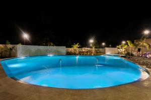 a large blue swimming pool at night at Fairfield by Marriott Luquillo Beach in Luquillo +36 photos