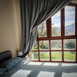a bedroom with a large window with a view at Eguzkitza in Iturriotz