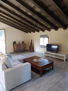 a living room with a white couch and a coffee table at Eguzkitza in Iturriotz