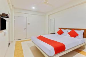 sypialnia z dużym łóżkiem z czerwonymi poduszkami w obiekcie Chaitanya Near Fun Time Multiplex w mieście Yerandwane