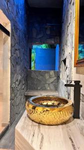 a large stone tub sitting in a room at Hotel Suites Lounge La Viga in Cali