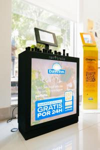 a television screen with a sign on top of it at Days Inn by Wyndham Rio de Janeiro Lapa in Rio de Janeiro