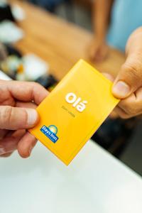 a person holding a yellow object in their hand at Days Inn by Wyndham Rio de Janeiro Lapa in Rio de Janeiro