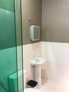 a bathroom with a sink and a shower at Atalaia VIP Praia Hotel in Salinópolis