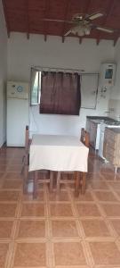 a kitchen with a table with a white table cloth on it at Cabañas Nicasio in Merlo